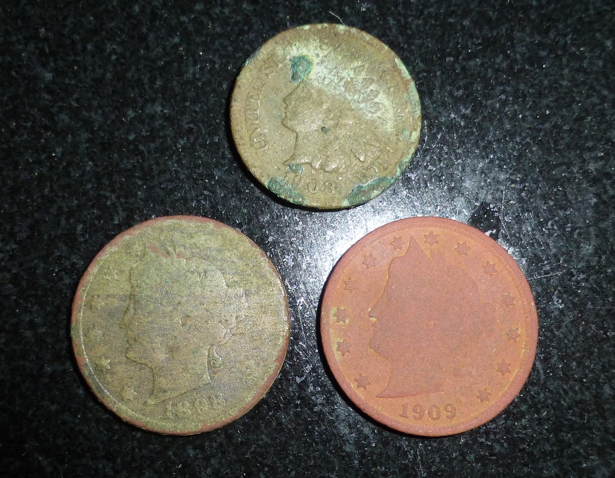 Two indian nickels and an Indian head penny